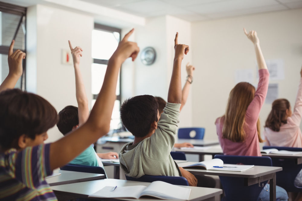85511School kids raising hand in classroom